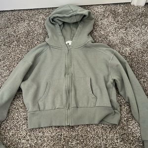 A light green crop top sweater